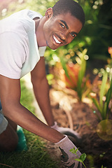 Image showing Portrait, nature and planting flowers with black man in garden of home for summer landscaping. Face, smile and gardening with happy young person outdoor in backyard for growth or green cultivation