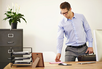 Image showing Desk, letter and confused business man with briefcase in office looking worried for employment. Anxiety, doubt or frown and young employee with glasses in professional workplace for notification