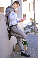 Image showing Businessman, city and unemployment with job loss or stress and thinking of career crisis. Salesman, pink slip and mental health or anxiety in street, reading and fired or termination of work contract