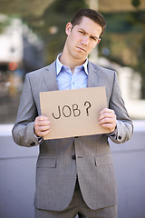 Image showing Poster, jobless and stress for man with suit, outdoor and adult with unemployment with poverty. Male person, search and hunting for work with cardboard sign on street in city of Cape Town for career