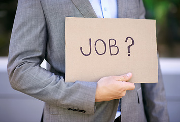 Image showing Hand, businessman and board for unemployed, jobless and poverty for adult, search or hunting for work. Economy, poor and male person as accountant showing sign on street in city of Cape Town