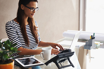 Image showing Woman, desk and computer with blueprints for interior design or creative career, happy and working on graphics on laptop. Online, search and plan project with digital technology and information