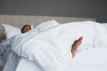 Image showing Lazy, feet and woman in bedroom sleeping, house and white duvet for bedding, nap and exhausted. Morning, dream and female person on day off to relax in apartment, rest and cosy with blanket on bed