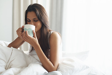 Image showing Smile, calm and woman with coffee in bedroom with caffeine to wake up in morning at home. Happy, relax and comfy young female person drinking mug of cappuccino, espresso or latte in apartment.