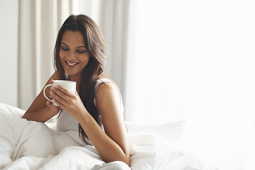 Image showing Happy, calm and woman with coffee in bedroom with caffeine to wake up in morning at home. Smile, relax and comfy young female person drinking mug of cappuccino, espresso or latte in apartment.