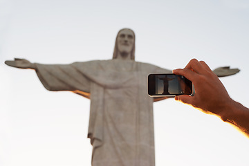 Image showing Jesus christ, statue or hand of tourist with photo of sculpture for travel or christian faith for art. Person, history monument or peace for tourism, God or religion symbol in Rio de Janeiro, Brazil