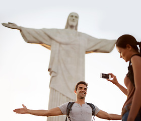 Image showing Tourist, happy and photograph with monument for sightseeing, freedom and christ the redeemer statue in Rio de Janeiro with girlfriend. Couple, explore and holiday for adventure or tour with cellphone