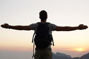 Image showing Man, silhouette and freedom with mountain, sunset and adventure for travel or holiday. Tourist, brazil and backpack with sunrise, view and nature for calm and fulfillment with hike for health