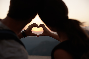 Image showing Travel, heart hands and couple in mountains with view of sky together on holiday or vacation abroad. Love, hiking or backpacking with emoji of man and woman outdoor for tourism overseas from back