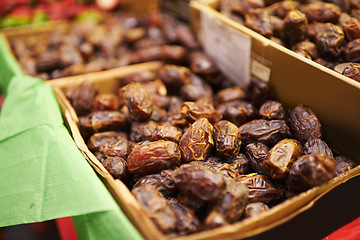 Image showing Harvest, natural and bunch of organic dates for nutrition, health and wellness diet snack. Sustainable, farmers market and dried fruit for vitamins, digestion or fiber on display in grocery store.