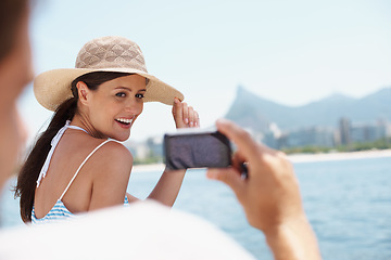 Image showing Happy woman, cellphone and picture on vacation, yacht and cruise on ocean. Social media, photography and honeymoon for married man and wife person, travel or seaside holiday in Hawaii for sunshine