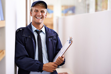 Image showing Portrait, smile and retail with courier man at office for distribution, shipping or service. Ecommerce, logistics or delivery and happy young postal worker with clipboard for manifest or order