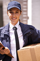 Image showing Delivery woman, box and outdoor in portrait by houses for distribution, smile or shipping job in neighborhood. Girl, courier and employee in supply chain, logistics or clipboard for cardboard package