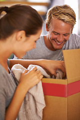 Image showing Couple, moving and packing clothes in box and excited for new house and preparing for property. People, unboxing and happy to rent real estate, apartment and start of marriage in home together