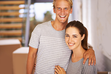 Image showing Real estate, couple and portrait for property investment, new home and moving in hallway of house. Happiness, face of man and woman with hug for relocation, mortgage loan and cardboard boxes.