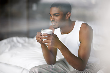 Image showing Black man, thinking and morning with coffee in bed for breakfast, start or ambition at home. Young African or male person in wonder, thought or relax with mug, cappuccino or cup of tea in the bedroom
