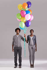 Image showing Couple, portrait and party with balloons for celebration, event or romance on a gray studio background. Man and woman holding colorful blowups of helium for art, date or anniversary on mockup space