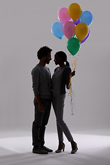 Image showing Couple, silhouette and party with balloons for celebration, event or romance on a gray studio background. Man and woman holding colorful objects of helium for art, date or anniversary on mockup space