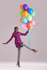 Image showing Balloon, excited and portrait of black woman in studio for birthday, celebration and present. Happy, fashion and isolated person smile with inflatables for party, gift and surprise on gray background