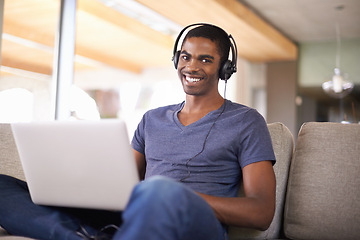 Image showing Man, portrait and music with laptop on couch for internet streaming, podcast or online research with smile. Student, black person or technology with headphones for relax, studying or learning in home