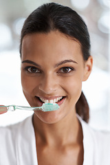 Image showing Woman, brushing teeth and toothbrush for dental, portrait with smile in bathroom for morning routine. Oral hygiene, wellness and orthodontics with toothpaste for fresh breath, health and self care