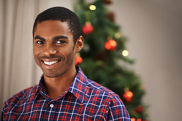 Image showing Man, portrait and happy in home on christmas for celebration, holiday and festive spirit in living room. African person, face and smile on xmas with relax, confidence and vacation in lounge of house