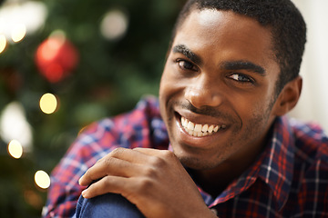 Image showing Man, portrait and smile in home on christmas for celebration, holiday and festive spirit in living room. African person, face and happy on xmas with relax, confidence and vacation in lounge of house