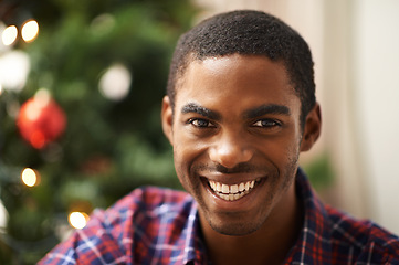 Image showing Man, portrait and smile in home on christmas for celebration, holiday and festive spirit in living room. African person, face and happy on xmas with relax, confidence and vacation in lounge of house