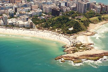 Image showing Coastline, holiday and drone with seaside, city and environment with vacation and getaway trip with nature. Landscape, aerial view and summer with water or waves with sunshine or buildings with break