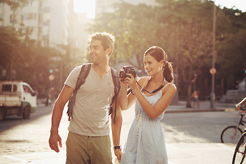 Image showing Couple, tourist and photography in street for travel, sightseeing and happiness on holiday or vacation in Brazil. Camera, man and woman with smile in city road for explore, tourism or journey in town