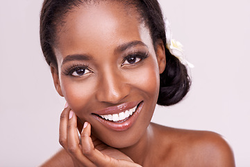 Image showing Woman, portrait and skincare for beauty in studio with cosmetics, natural glow and self care with smile. Model, african person or face for cosmetology, facial treatment and makeup on white background