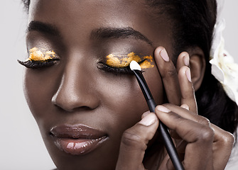 Image showing Brush, makeup and face of black woman in studio for wellness, beauty and aesthetic. Cosmetology, skincare and person with tools for makeover application, eyeshadow and products on a white background