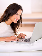 Image showing Woman, smile and laptop on couch at home, living room and apartment for remote work, virtual job and creative career. Female person, freelancer or writer for online publication, blog or email
