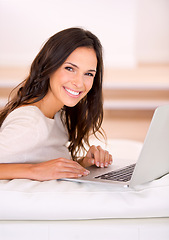 Image showing Woman, laptop and happy on sofa for portrait with remote work from home, living room or freelance editing. Person, writer and smile with pc on couch for typing, creativity and article in Barcelona