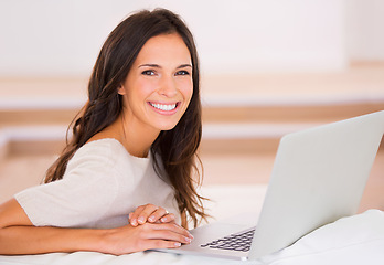 Image showing Woman, laptop and smile on sofa with remote work from home in portrait, living room and freelance editing. Person, writer and happy with pc on couch for typing, creativity and article in Barcelona
