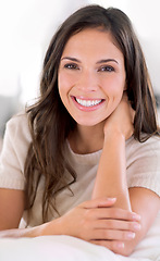 Image showing Woman, happy and portrait on sofa to relax in home with pride, holiday and confidence in living room. Person, smile and morning on vacation, break and lounge with couch at apartment in Barcelona