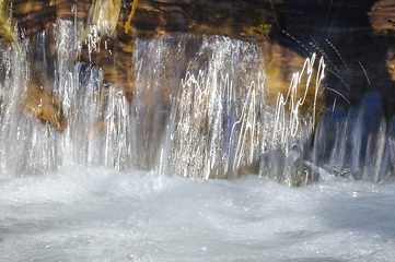 Image showing Close-up view of a serene waterfall cascading over rocky ledges 