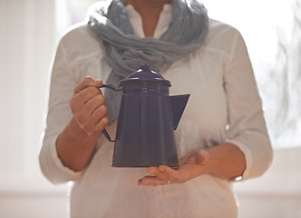 Image showing Hands, teapot and window with closeup, kitchen and retirement with gratitude and relaxing. Mature person, kettle and hold with drink, home and coffee or tea for routine and break in family house