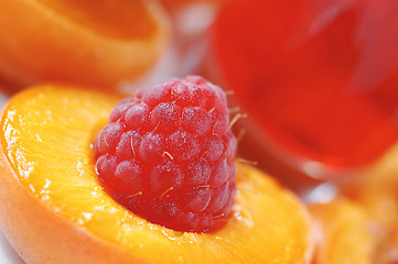 Image showing Raspberry in halved peach