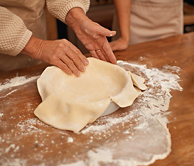 Image showing Hands, flour and people baking in kitchen of home together closeup with ingredients for recipe. Cooking, food or dough with chef and baker in apartment for fresh pastry preparation from above