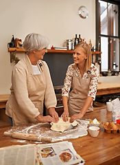 Image showing Senior mom, daughter and baking together while learning, teaching and laughing or cooking in kitchen for family bonding. Mature woman, lady and mentor for help on secret recipe or homemade veg pie