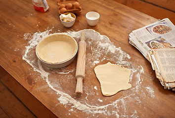 Image showing Preparation, counter and ingredients for dough or pastry with no people, ready for filling and baking or cooking for easter holiday. Books, recipes and pan for sweet handmade pie for dessert or snack