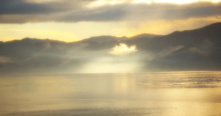 Image showing Beach, sunset and sea with clouds, view and drone for aesthetic and travel environment and sunshine. Beautiful sky, ocean and landscape in Miami, trip and vacation for nature and sunlight tranquility