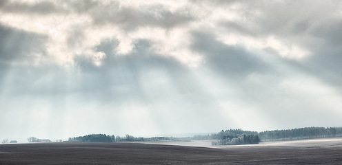 Image showing Sky, clouds or sunshine in nature, outdoor or climate with field, land or heaven background. Countryside, cloud or natural environment for meteorology, weather and air with light, remote or landscape