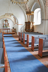 Image showing Christian, shrine or altar in church for religion, worship and spiritual space for ceremony in Danish culture. Praise, god and sculpture of Jesus in chapel with furniture, seat on aisle and hallway