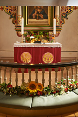 Image showing Christian, shrine or altar in church for religion, worship and spiritual space for Catholic ceremony or culture. Praise, god and painting of Jesus in chapel with candles and holy bible on table