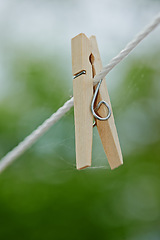 Image showing Peg, rope and outdoor for clothes from laundry, clean and dry in nature with plastic clip of closeup. Washing, empty line and wooden tool to hang or pin cloth on wire, fasten and backyard AT house