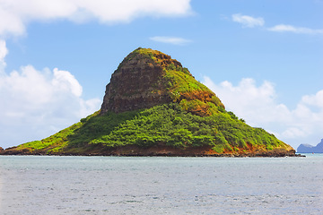 Image showing Mountain, island and natural landscape with blue sky, summer and calm clouds on peak at travel location. Nature, cliff and sustainable environment with earth, drone and tropical holiday destination