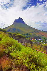 Image showing Mountain, sunshine and valley at peak with cloudy sky, summer and trees in countryside at travel location. Nature, cliff and sustainable environment with earth, bush and tropical holiday destination