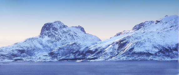 Image showing Mountain, snow and nature with environment for blue sky, travel and outdoor adventure in cold weather. Banner, arctic and alps for winter season, remote location and vacation in natural landscape.